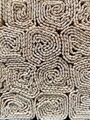 Background decorative napkins made of wood are rolled up and folded in the form of a structure.