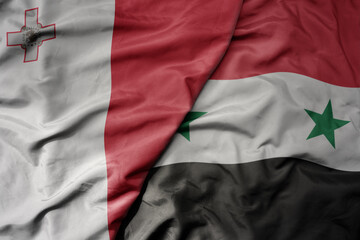 Fototapeta premium big waving national colorful flag of syria and national flag of malta.