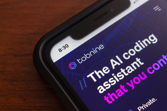 Vancouver, CANADA - Feb 14 2024 : Website of Tabnine AI seen in iPhone. Tabnine is an AI-powered tool that enhances coding productivity and efficiency through code completion and knowledge expansion