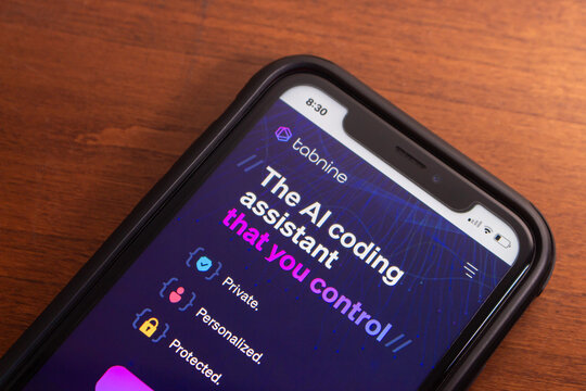 Vancouver, CANADA - Feb 14 2024 : Website of Tabnine AI seen in iPhone. Tabnine is an AI-powered tool that enhances coding productivity and efficiency through code completion and knowledge expansion