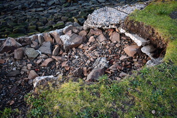 Edge of water-way eroding away. Large sinkhole.