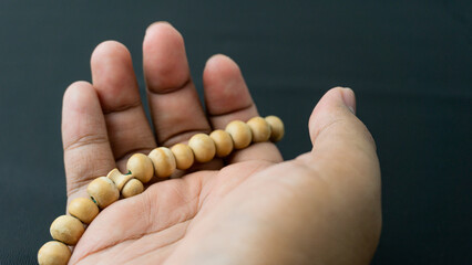 Tasbih made of wood to be used for dhikr dzikir on the hands. On black background