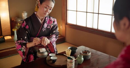Herbs, teapot and Japanese women with tea for culture with traditional leaves and wellness in home. Friends, ceremony and people with herbal beverage for relaxing, calm and detox for drinking ritual
