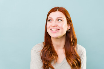 Attractive ginger woman with red hair looking cheerful