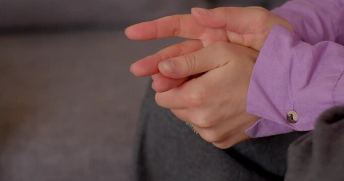 Hands close-up during therapy session with psychotherapist. Woman struggles with memories of traumatic moments of childhood. Her emotions betray the pain within. Emotional healing and trauma recovery.