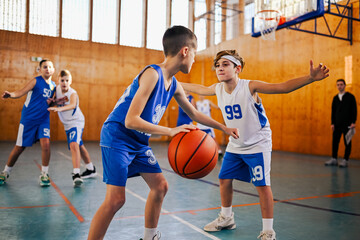 A junior basketball team playing basket on training and practicing game.