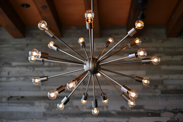 Contemporary chandelier with polished nickel arms and exposed bulbs.