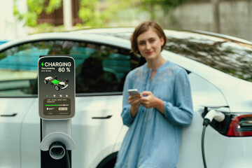 Electric vehicle recharging battery from home EV charging station using alternative energy with net...