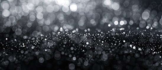 A black and white photograph with a blurred background, featuring a mesmerizing blend of black,...