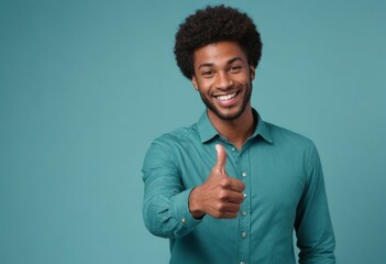 A man with a radiant smile in a teal shirt gives a thumbs up, signaling happiness and approval.