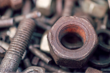 A close up of a rustic old nut and screws captured in stunning details.