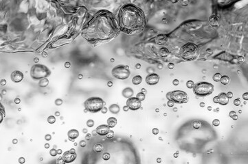 Close up of black and white colors transparent air bubbles in water.