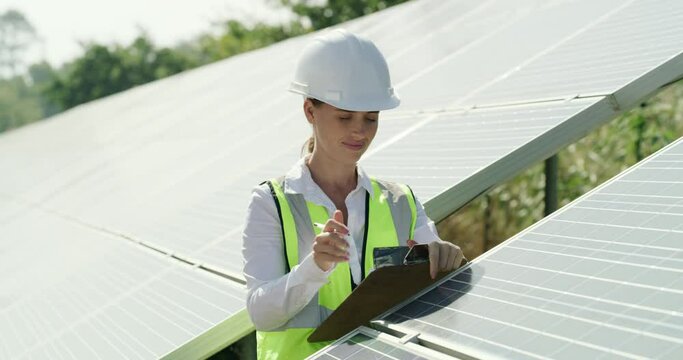 Solar panel, engineer and woman with clipboard for maintenance outdoor in nature. Photovoltaic, checklist and electrician in inspection, writing and renewable energy at power plant for sustainability
