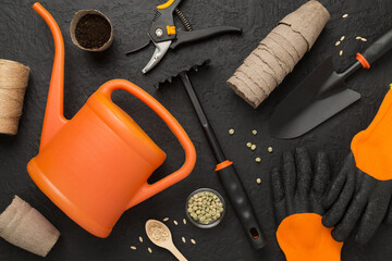 Orange gardening tools on conctere background, top view