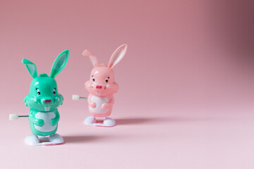 Toy rabbits on pink background with copy space. Easter concept