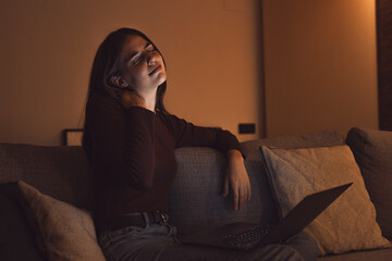 Stressed woman at late night having strong terrible neckache attack after computer laptop study,...