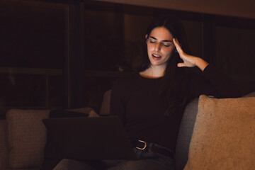 Stressed woman at late night having strong terrible headache attack after computer laptop study, sleepy exhausted girl suffering from chronic migraine massaging temples to relieve head ache tension.