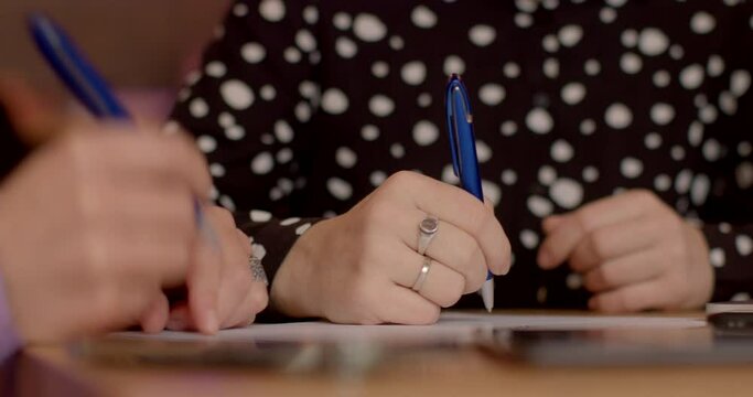 Close-up of business paper and contracts signing. Business documents and contracts being signed, emphasizing attention to detail and legal commitments. Hands of people closeup.