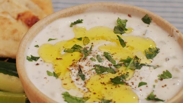 Greek Tzatziki sauce of salted strained yogurt or diluted yogurt mixed with cucumbers and mint, garlic, salt, olive oil on top.
