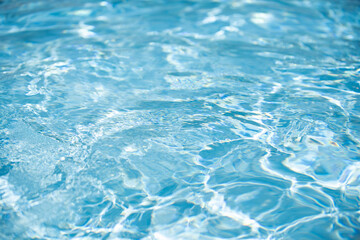 Ripped water in swimming pool. Surface of blue swimming pool, background of water.