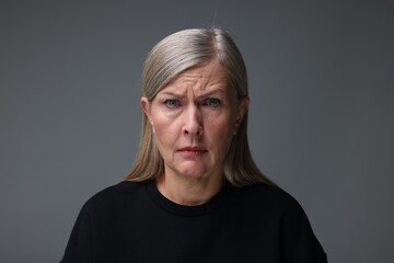 Personality concept. Portrait of emotional woman on gray background