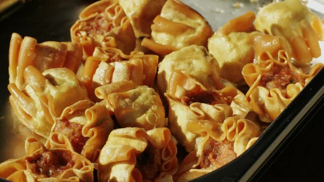 Traditional chinese spicy chicken gizzards close-up. Asian chicken stomach popular food. Local street food market outdoor.