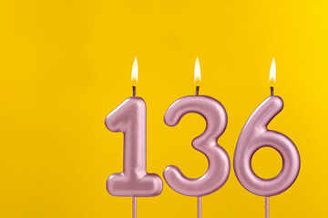 Birthday candle number 136 - Birthday celebration on yellow background