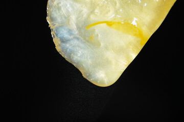 Close up of squeezing orange juice using hand