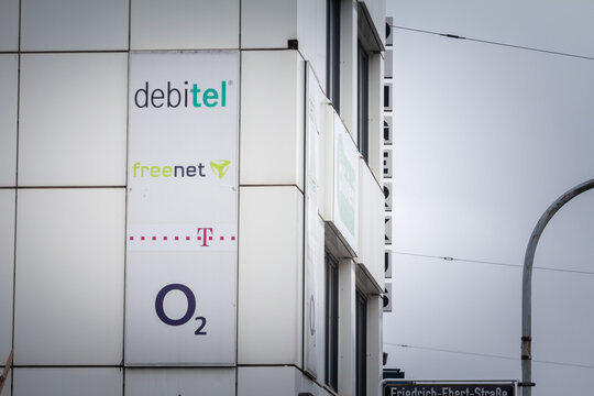 DUSSELDORF, GERMANY - NOVEMBER 7, 2022: 4 phone carriers & internet service providers of Germany: T-Mobile, Freenet, Debitel & O2 on retailer. They're offering telecom & mobile phone services.