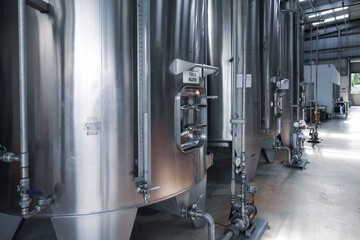 Row of stainless steel fermentation tanks