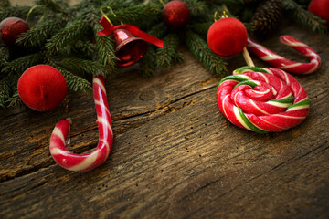 Christmas border with fir tree branches, cones, christmas decorations and candy canes