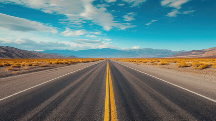 Naklejka premium Desert road stretching towards mountainous horizon under a vast sky in rural showcasing the empty asphalt route for a scenic journey through nature
