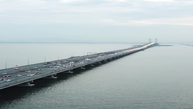 Aerial footage of Penang Bridge and TNB Monopole Transmission Tower construction. Construction and Transportation industry. Landmark and iconic structure. Megastructure bridge. Connecting roadways.