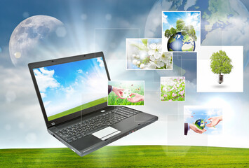 Laptop against green nature background