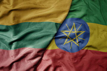 big waving national colorful flag of ethiopia and national flag of lithuania .