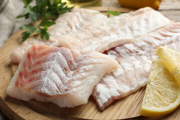 Fresh raw cod fillets on wooden table, closeup