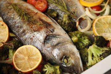 Delicious fish with vegetables and lemon, closeup