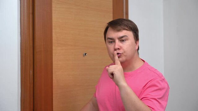 Man closes front door, puts finger to lips, asks for silence, looks closely, bulges eyes in surprise, faints from unexpected fright. Parenthood, strict father, children's pranks, family tomfoolery