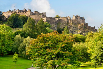 Edinburgh, Scotland - Edinburgh Castle, perched on its rock above the trees on Princes Street...