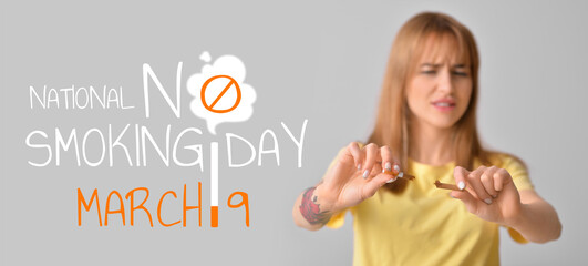 Young woman with broken cigarette on grey background. Concept of refusing from bad habit