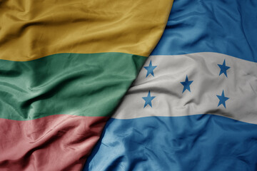 big waving national colorful flag of honduras and national flag of lithuania .