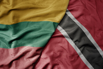 big waving national colorful flag of trinidad and tobago and national flag of lithuania .