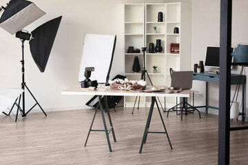Interior of photo studio with tables and professional equipment