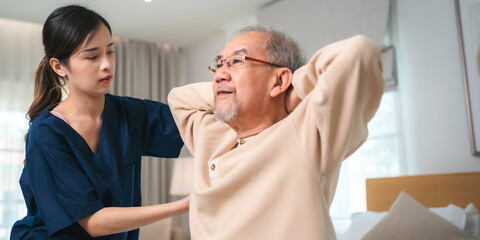 Obraz premium Young asian female nurse care giver helping asian senior old man in living area of nursing home senior daycare center, Nurse take care elderly patient with cheerful concentrate, health insurance