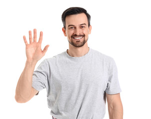 Obraz premium Smiling man waving hello with open hand gesture, friendly greeting and communication concept, isolated on white background