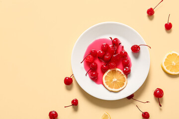 Plate of tasty maraschino cherries and lemon on yellow background
