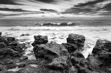This BnW photograph showcases the raw power of the ocean against a rugged coastline, perfect for those seeking to convey the dramatic beauty of nature or to add a timeless oceanic theme to their space