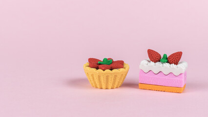 Two types of cakes on a pink background.