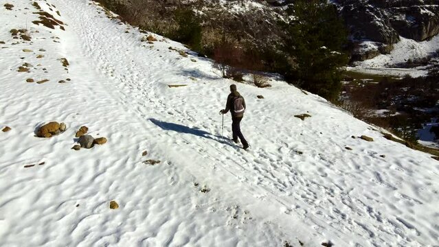 Man doing winter hiking among the snowy mountains of the Spanish Pyrenees
