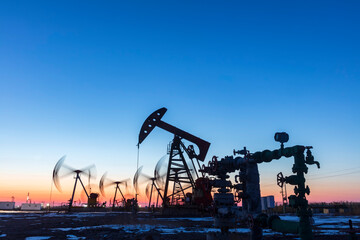 In the evening, oil pumps are running, Silhouette of beam pumping unit
